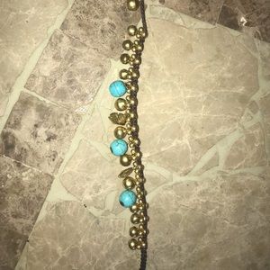A woven turquoise stone bracelet from.